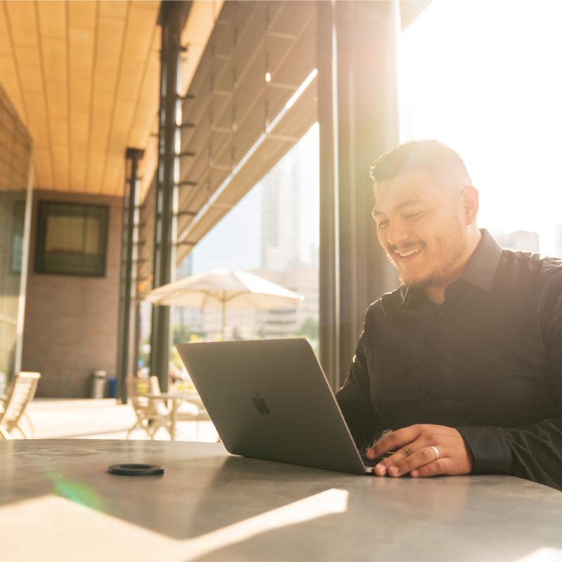 Student working outside on laptop