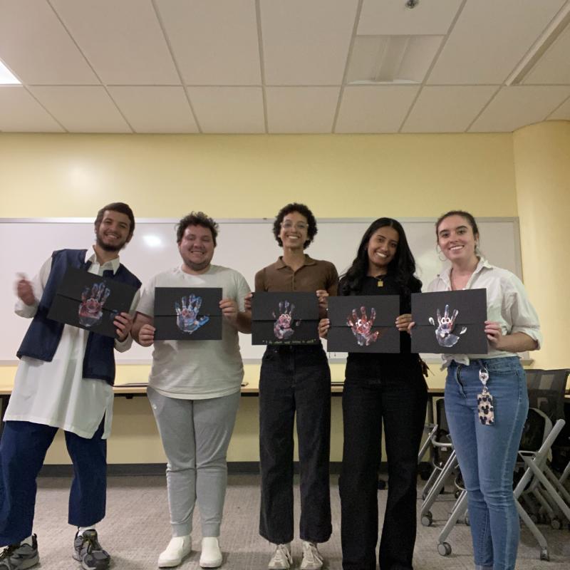 students-holding-certificates-with-handprint