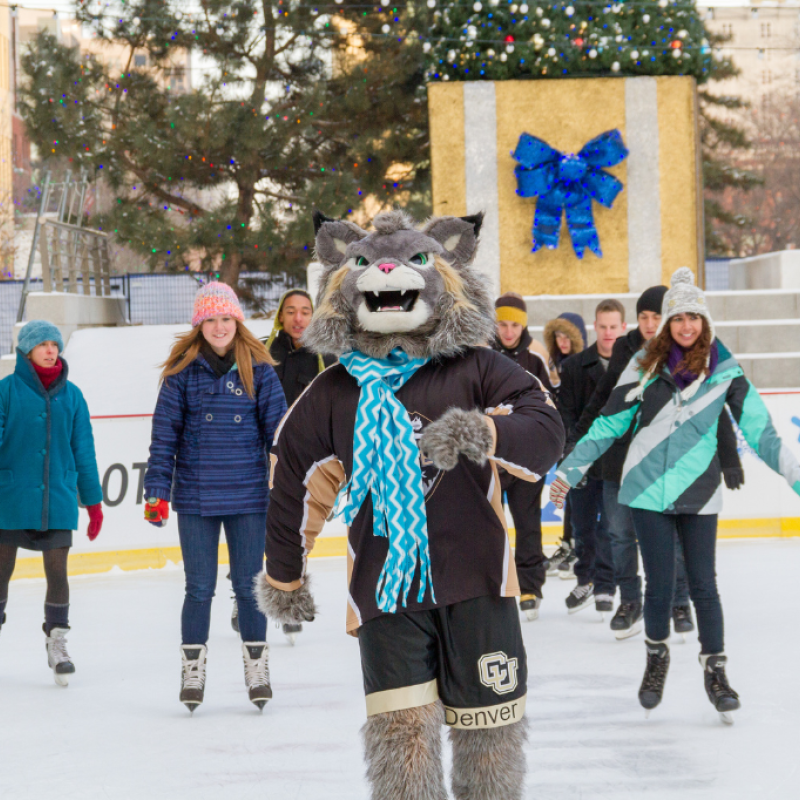 students ice skating with Milo the mascot