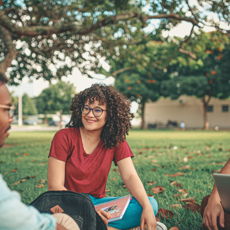students sitting in grass
