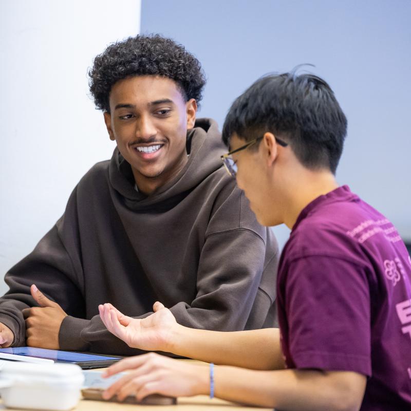 Two CU Denver students working in a classroom