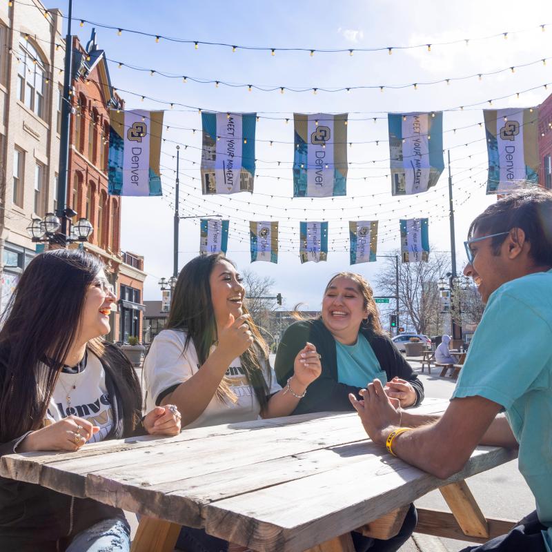 Students sitting at a picnic table in Denver